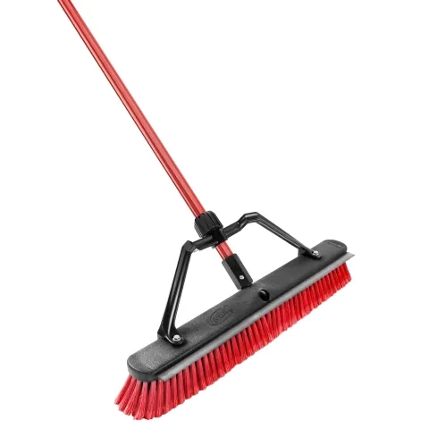 Push broom with red fibers and a red handle
